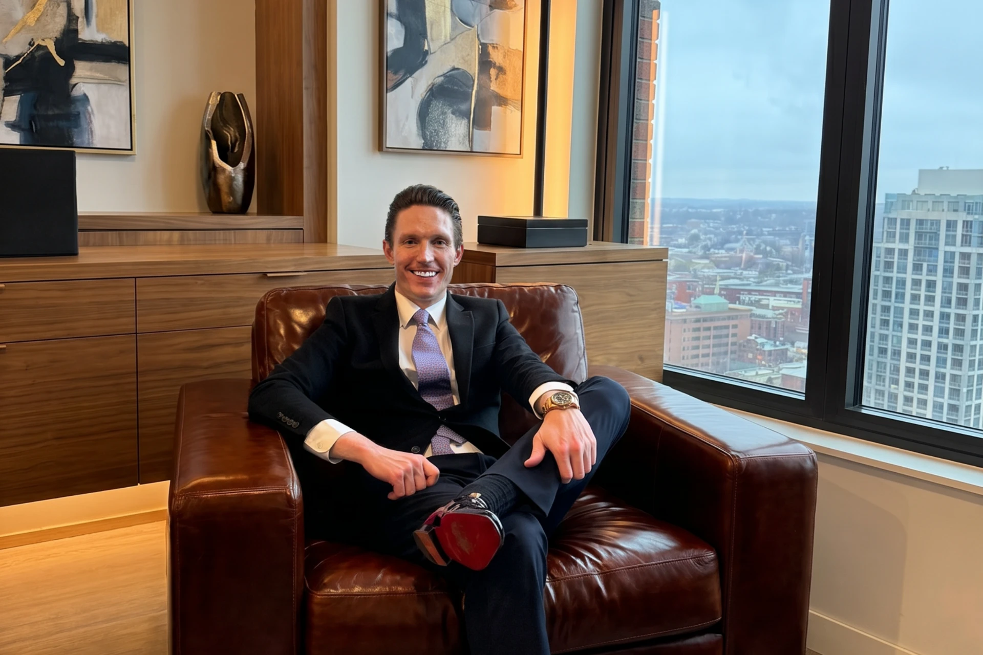 Mike Wilen seated in a leather chair in his downtown office